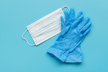 Plastic Glove and Face Mask on Blue Surface
